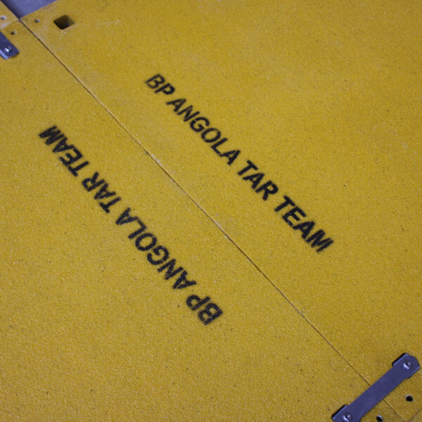Close up of the yellow solid top with BP Angola Tar Team written on it