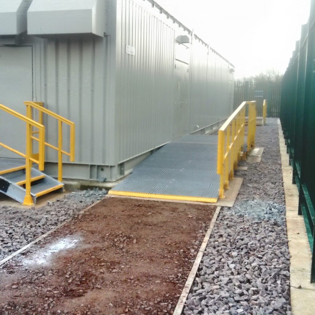Access ramp leading to a grey kiosk at Ampthill
